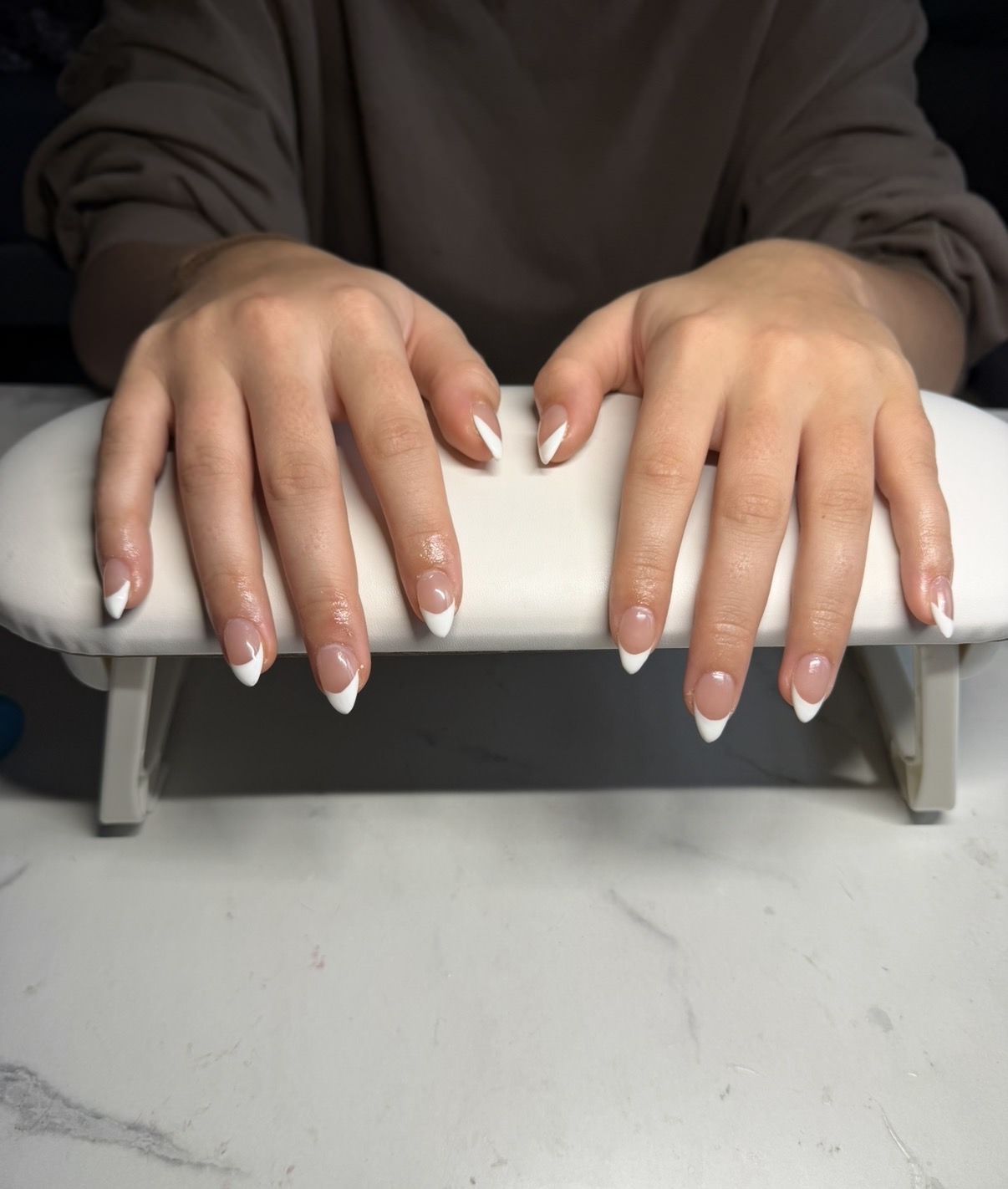 Tiny star-inspired French gel nails with glossy white tips by Raegan