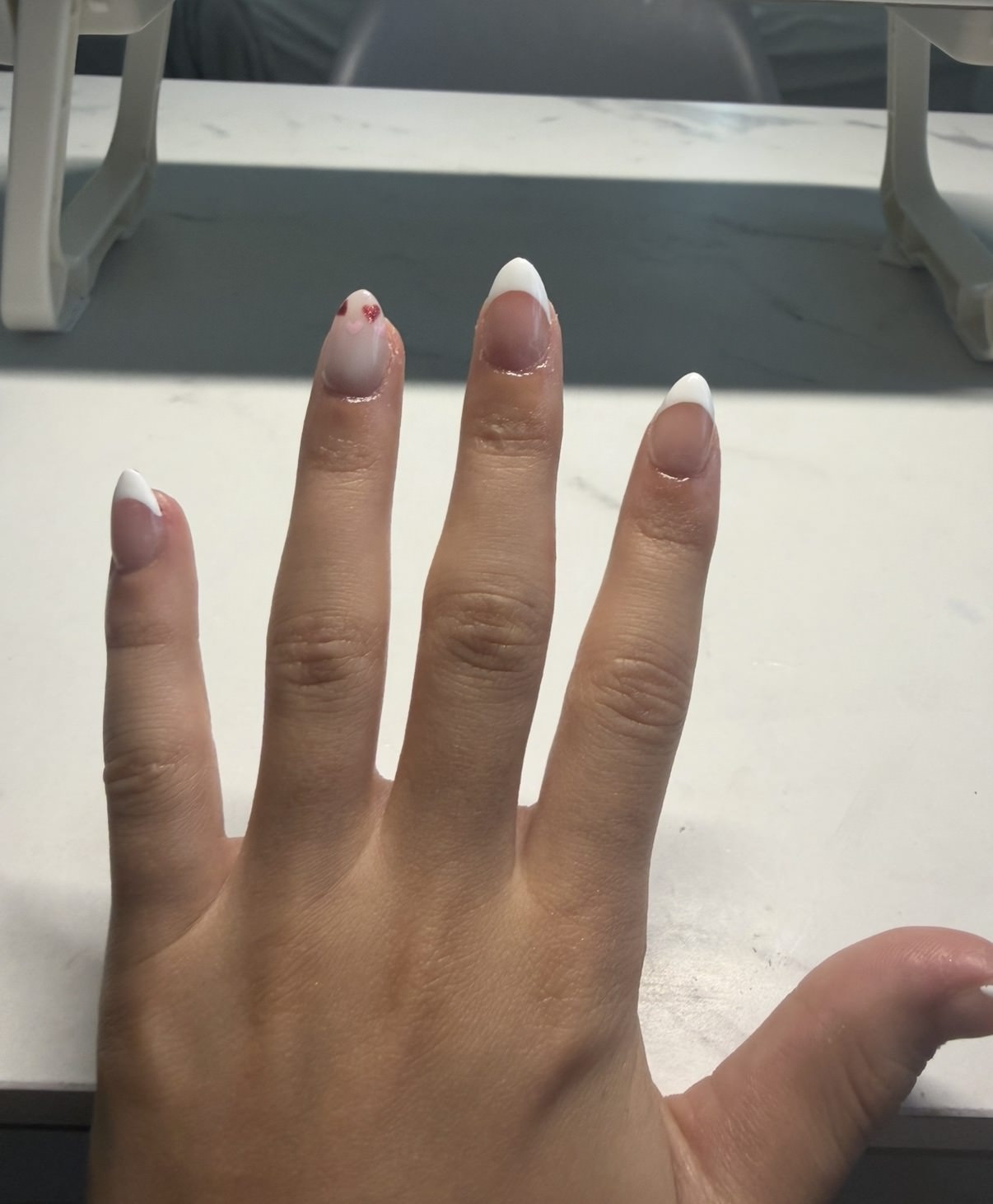 Cocoa chrome tip French nail detail with glossy white almond tips by Raegan